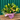 A fresh flower bouquet with yellow lily buds, green foliage, and peach-pink lilies arranged in a purple box wrapped in pink tissue paper, set on a wooden bench against a teal corrugated metal background.